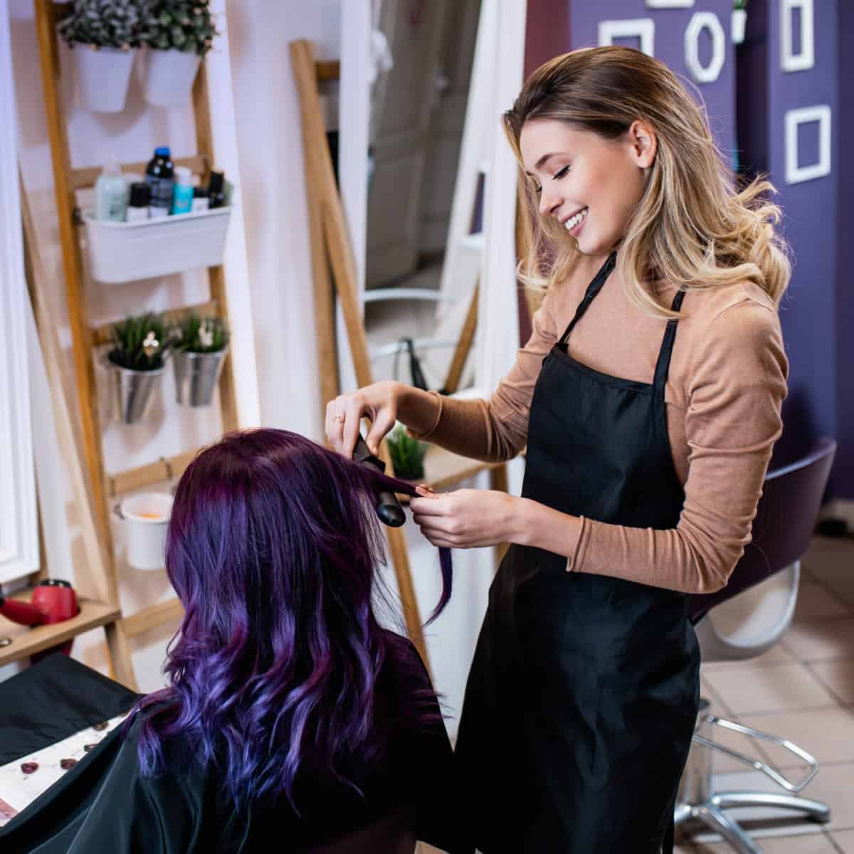 Hair stylist cutting hair on client
